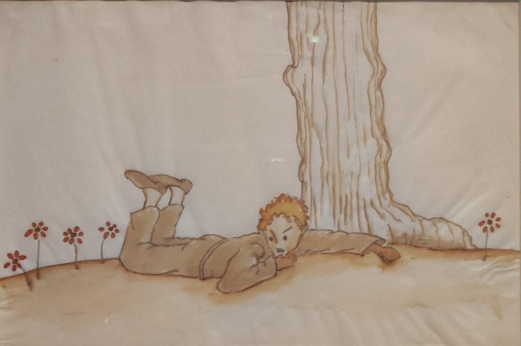 Dessin du Petit Prince allongé dans l'herbe